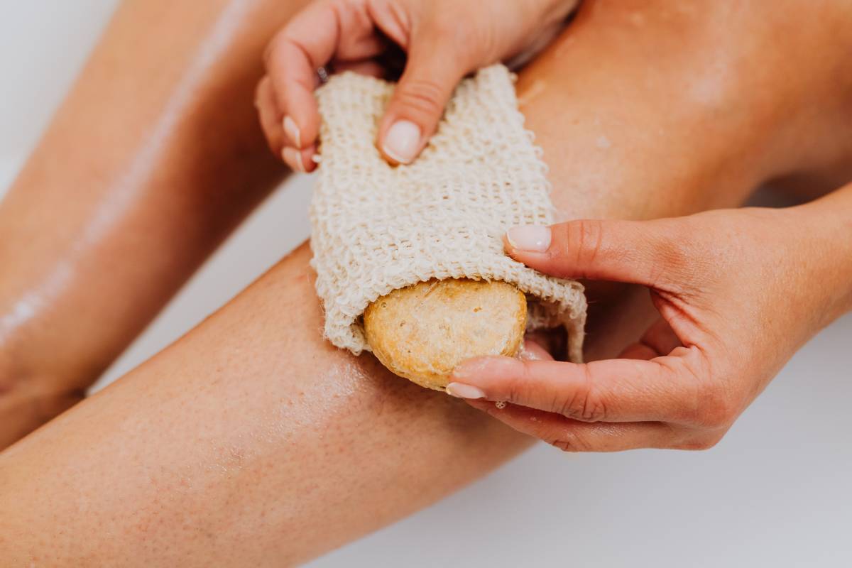 Side-by-side comparison of natural loofah sponge vs. synthetic plastic loofah showing texture and structure differences