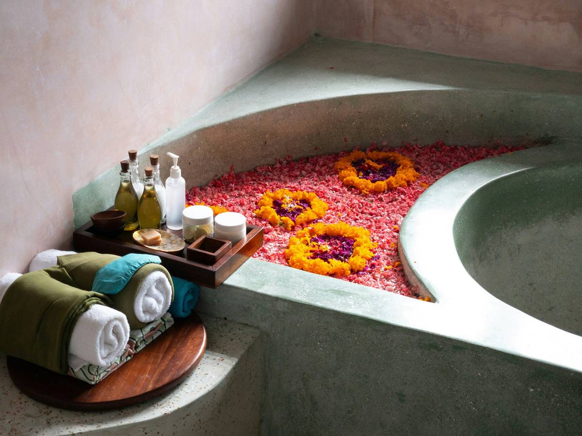 Natural loofah bath mat drying quickly on bathroom floor